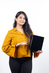 Fototapeta premium Young Indian, asian business woman, collage girl, student, confident female entrepreneur wearing professional outfit dress pointing at tablet for advertisement isolated on white background