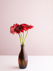 A Brown Vase with Gerbera Flowers.
