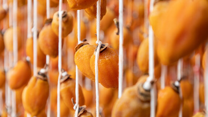 Hanging persimmon - Japanese Dried Persimmon (Hoshigaki) hanged on strings to dry a common sight