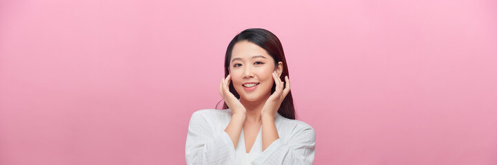 Banner of Young slim woman who gently touches and strokes her jawline and look at the camera.
