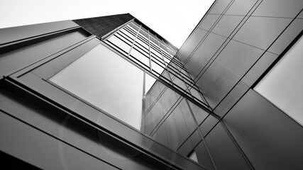 Abstract reflection of modern city glass facades. Modern office building detail, glass surface. Black and white.