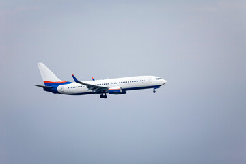 Fototapeta na wymiar airplane inflight in the blue sky shortly before landing
