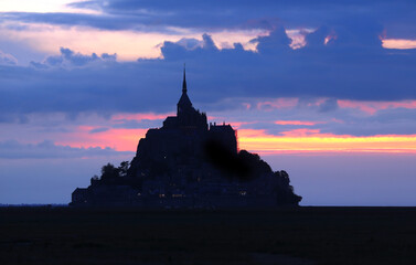 Enchanting Sunset Silhouette of Mont Saint-Michel Abbey on the French Coastline