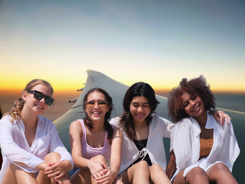 Dream Travel and study abroad concept - group of friend over air plane wing at the sunrise sky background, Student interesting to study abroad