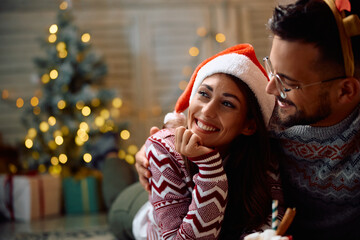 Happy woman enjoys in Christmas with her boyfriend at home.