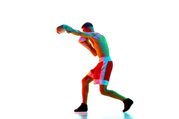 Fototapeta na wymiar Side view. Active shirtless male boxer, mixed martial art fighter workout against white background in mixed neon filter, light.