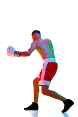 Athletics man, sportsman, boxer, fighter exercising before fight against white background in mixed neon filter, light.