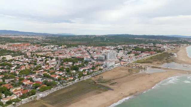 Aerial drone view of the coastal town named Comarruga in the province of Tarragona, Spain