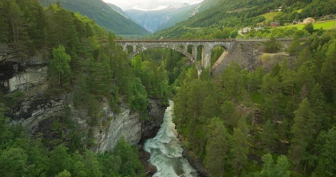 Scenic Kylling stone bridge spanning Rauma river in Romsdalen Valley. Aerial