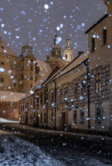 Wawel castle and Wawel cathedral from kanonicza street during snowfall in the night, Krakow, Poland