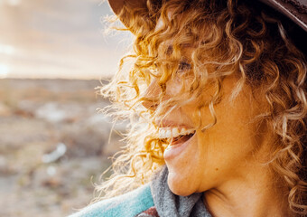 Side view portrait of overjoyed happy young adult woman smiling and having fu laughing in outdoor...