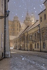 Wawel castle and Wawel cathedral from kanonicza street during snowfall in the night, Krakow, Poland - 670924168