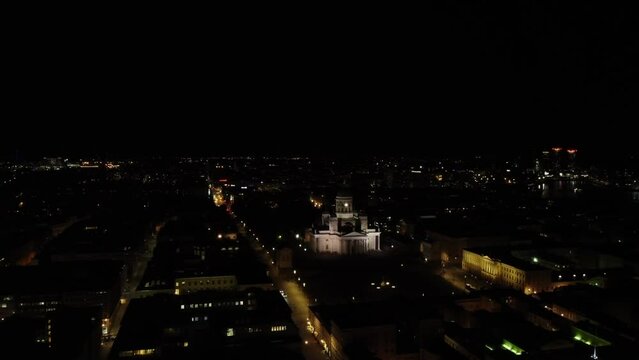Helsinki Cathedral Catholic church lit up on dark night, aerial view