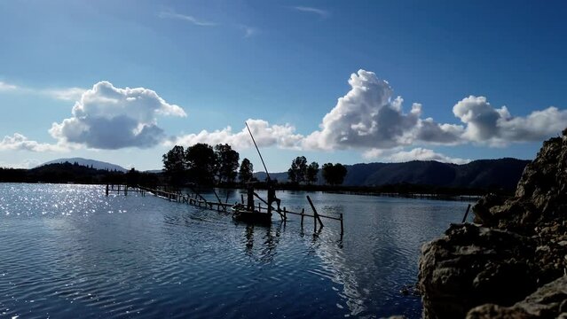 Fishermen collecting mussels the traditional way near Butrint archeological site. Albania, Balkans, Europe