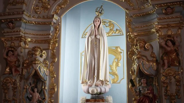 Elegant church shrine with Virgin Mary surrounded by golden carvings