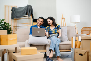 Asian young attractive couple man and woman use tablet and smartphone online shopping furniture...