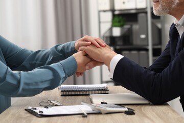 Trust and deal. Woman with man joining hands in office, closeup