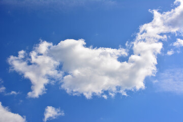 Naklejka na ściany i meble white cloud in the shape of wing isolated on blue sky