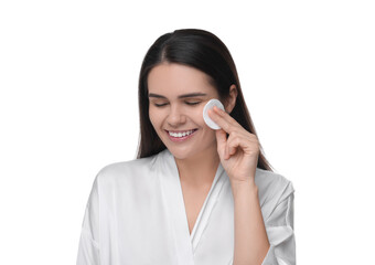 Young woman cleaning her face with cotton pad on white background