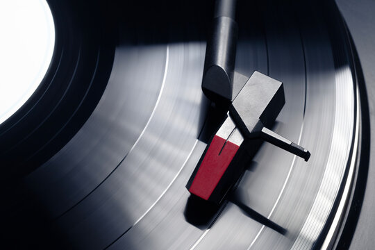 Turntable plays vinyl, high contrast and motion blur