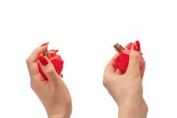 Red bottle of perfume in woman hand with red nails isolated on a white background.