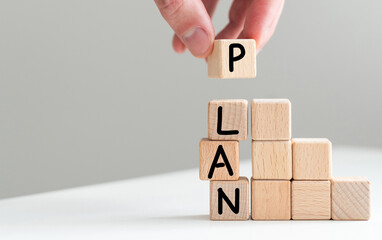 Wooden cubes with the word PLAN with copy space. business plan concept. 