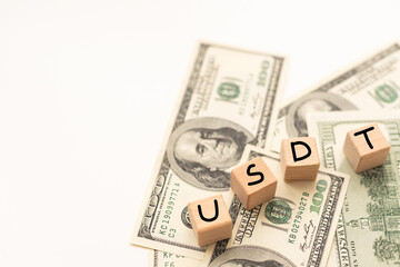 Wooden cubes with USDT and up-down arrows over 100 usd.