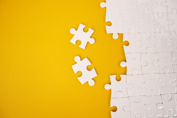 White details of the puzzle on a yellow background. White jigsaw puzzle.