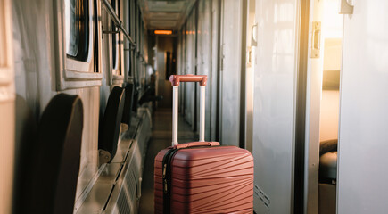 Red suitcase in the train. Baggage standing in the corridor of night sleeping train, Nobody. Empty...