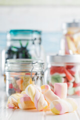 Sweet colorful marshmallows on white kitchen table.