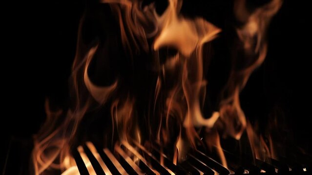The fire burns through the grill grate. Hellish barbecue. Hearth in the fireplace.