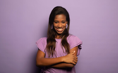 beautiful african-american woman smiling broadly over purple background