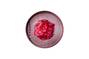Delicious spicy pink cabbage sliced and cooked in Korean style on a ceramic plate