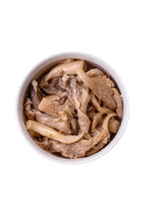 Delicious spicy mushrooms sliced and cooked in Korean style on a ceramic plate