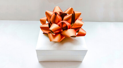White gift box with a gold bow on a white background. Holiday concept