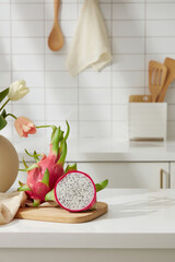White dragon fruit on wooden cutting board. Minimalist kitchen. Dragon fruit is a plant native to dry tropical regions, so it can withstand heat and drought well.