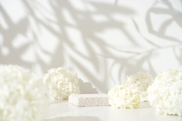 Obraz na płótnie Canvas Delicate cosmetics skin care product presentation scene made with pumice stone podium and white lilac flowers