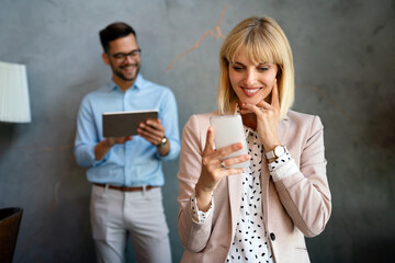 Fototapeta premium Beautiful successful businesswoman checking emails on the phone in modern office i