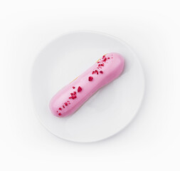 Eclair dessert with pink icing on plate