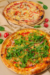 pizza with arugula and pizza with cheese and pepper