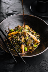Spicy dish, noodles with meat and vegetables in wok pan