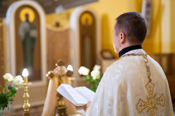 a priest in cassock leads a service in a Ukrainian church