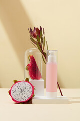 Skin care products with fresh dragon fruit extract. Props displayed on a minimalist background. Mockup for cosmetic advertising and branding.