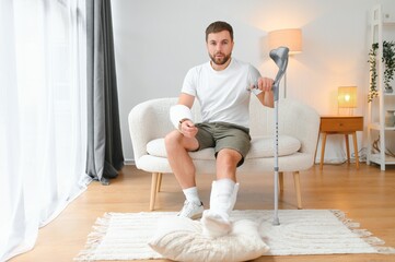man recovery from accident fracture broken bone injury with leg splints in cast neck splints collar...