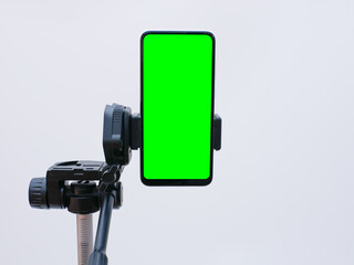 smartphone with green screen on tripod holder. smartphone mock up with chroma key