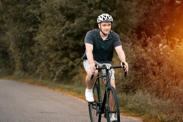 Man rides a bicycle. Into the Wilderness. Cycling Adventure in the Forest