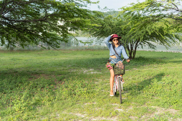 Latin Woman with bicycle on her way to the park