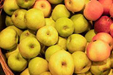Apples in wicker baskets in supermarket, top view