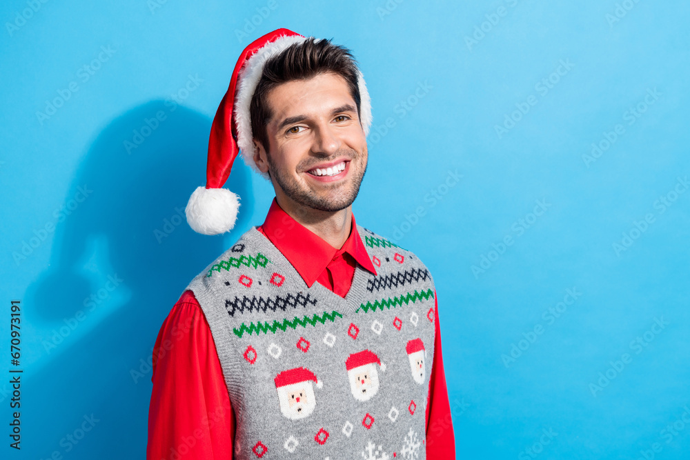 Sticker Photo portrait of cute young man toothy beaming smile dressed x-mas print vest hat clothes isolated on blue color background