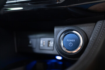 Blue power ignition button to start keyless ignition hybrid car engine Power button on a vehicle. - obrazy, fototapety, plakaty